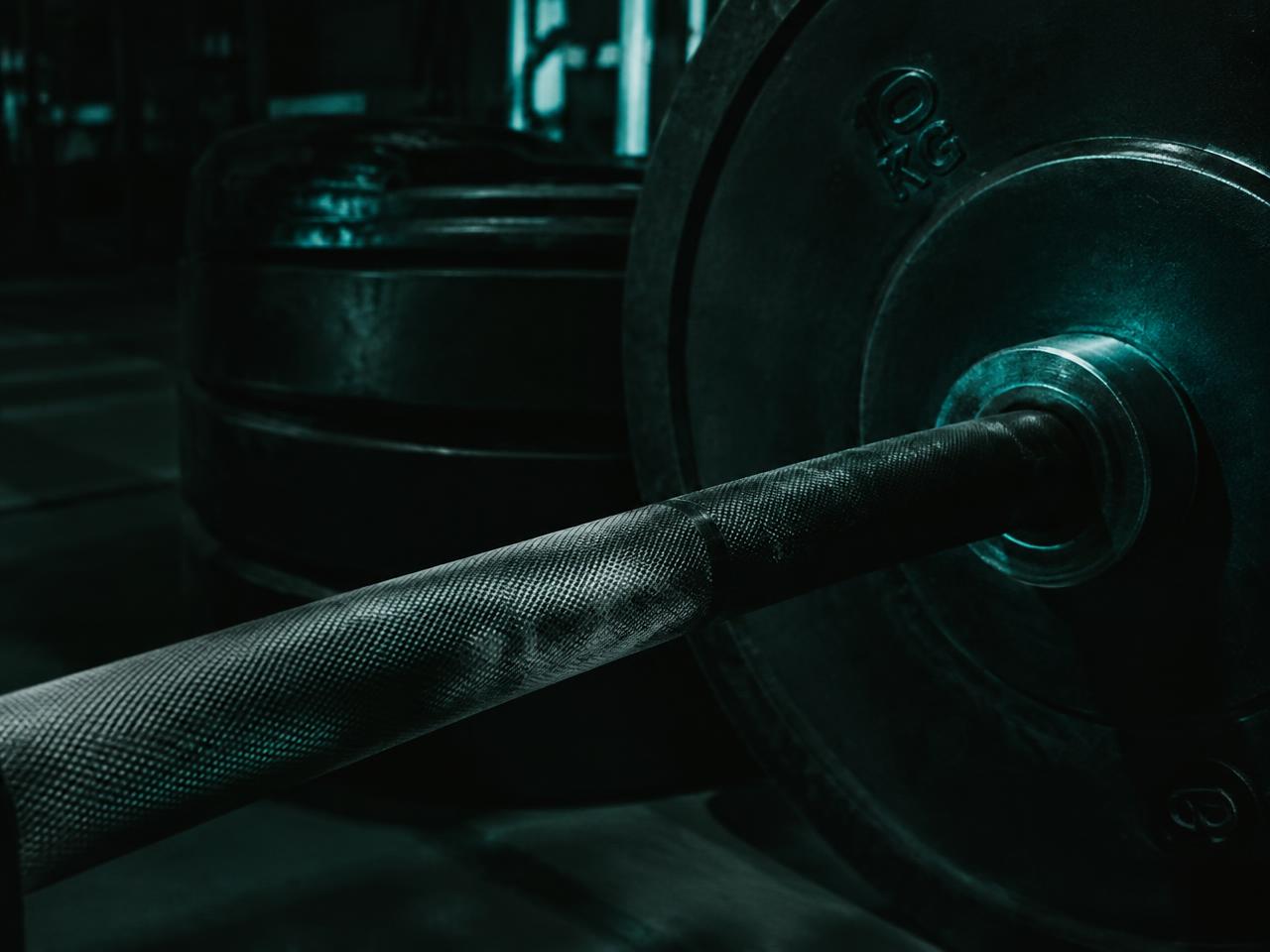 Close up of a competition barbell and calibrated plates